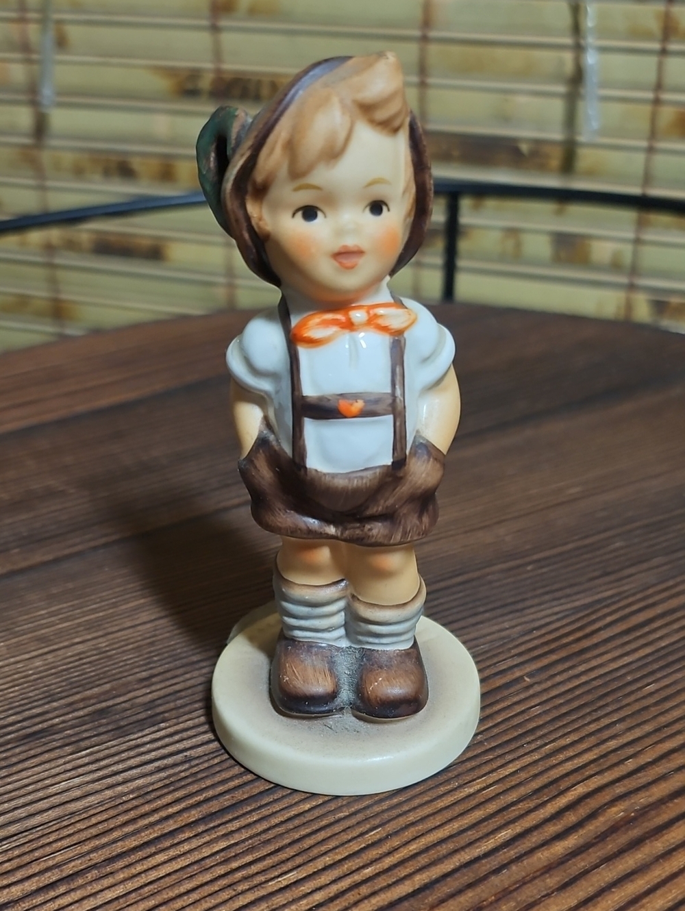 Hummel Brown, Cream and Orange Boy Figurine with Green Hat Accent
